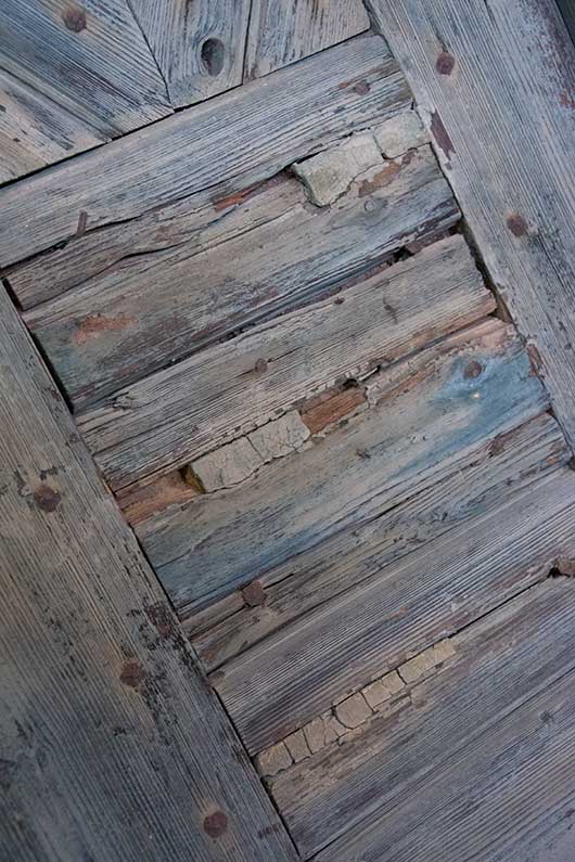 Antieke deur met houtsnijwerk en metalen hang- en sluitwerk